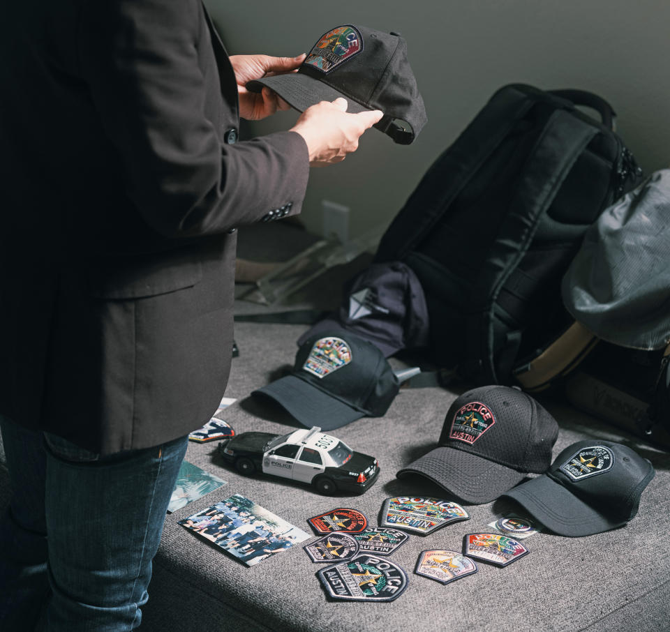 Christian Mendoza shows off some his police memorabilia. (Jordan Vonderhaar for NBC News)