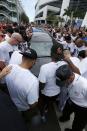 <p>Somber Miami Marlins players and staff surround a hearse carrying the body of pitcher Jose Fernandez as it leaves Marlins Park stadium, Wednesday, Sept. 28, 2016, in Miami. Fernandez, was killed in a weekend boat crash along with two friends. (AP Photo/Wilfredo Lee) </p>