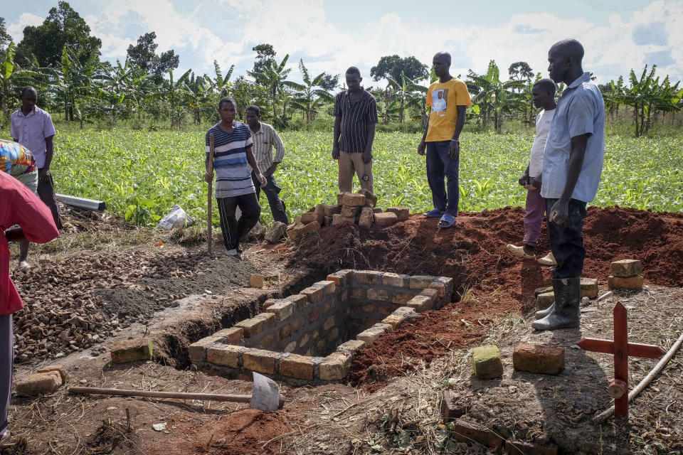 Relatives of a woman who died from Ebola prepare her grave in Kijavuzo village, Mubende district, Uganda, Thursday, Sept. 29, 2022. In this remote Ugandan community facing its first Ebola outbreak, testing trouble has added to the challenges with symptoms of the Sudan strain of Ebola now circulating being similar to malaria, underscoring the pitfalls health workers face in their response. (AP Photo/Hajarah Nalwadda)