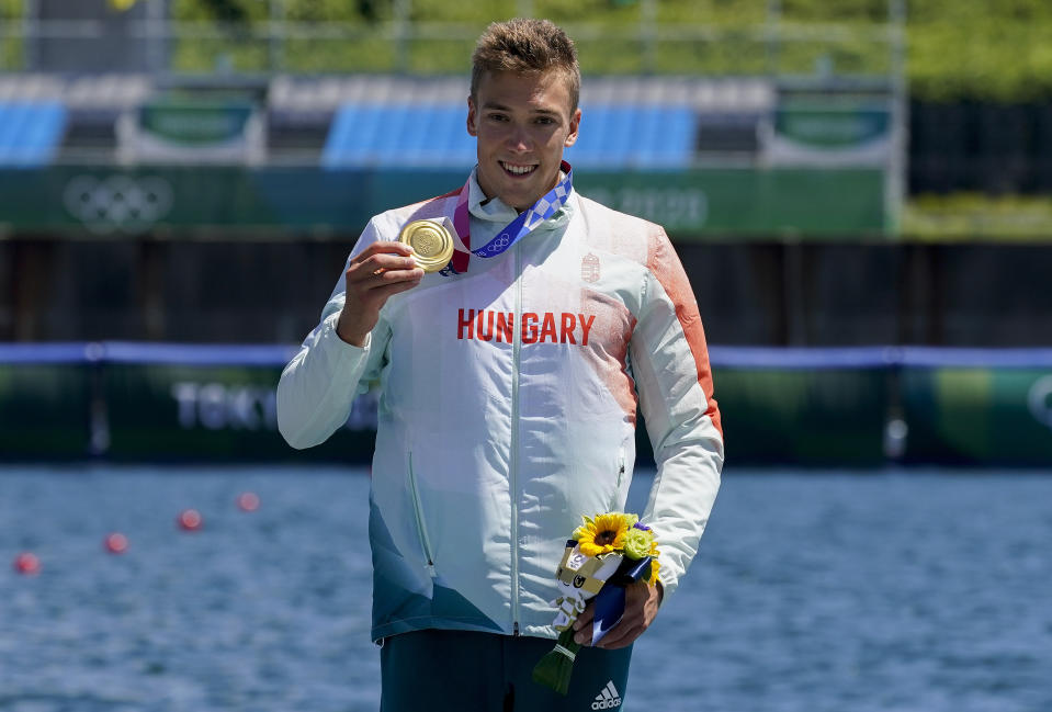 Balint Kopasz of Hungary, holds up his gold medal after winning the men's kayak single 1000m final at the 2020 Summer Olympics, Tuesday, Aug. 3, 2021, in Tokyo, Japan. (AP Photo/Darron Cummings)