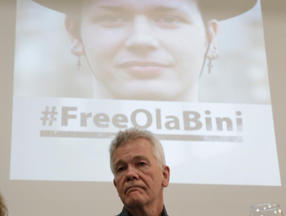 The father of detained Swedish programmer Ola Bini, Dag Gustafsson, attends a press conference in Quito, Ecuador, Tuesday, April 16, 2019. The ace Swedish programmer, pictured on the screen in the background, who was an early, ardent supporter of WikiLeaks was arrested in Ecuador last week in an alleged plot to blackmail the country's president over his abandonment of Julian Assange. (AP Photo/Dolores Ochoa)
