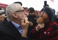 FILE - In this Saturday, Dec. 7, 2019 file photo Labour Party leader Jeremy Corbyn compares beards with a supporter during a visit to Swansea, while on the General Election campaign trail in Wales. (Victoria Jones/PA via AP, File)