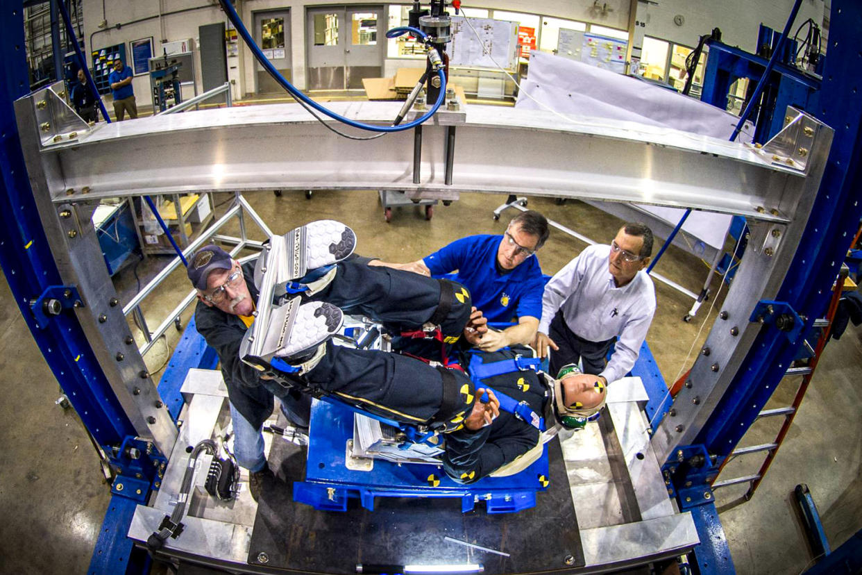 Engineers working with Boeing's CST-100 Starliner test the spacecraft's seat design. (Boeing)