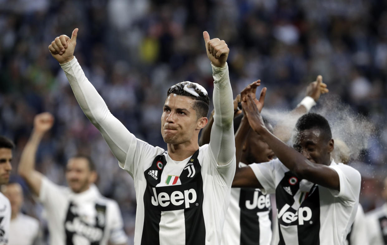 Juventus' Cristiano Ronaldo celebrates with his teammates at the end of a Serie A soccer match between Juventus and AC Fiorentina, at the Allianz stadium in Turin, Italy, Saturday, April 20, 2019. Juventus clinched a record-extending eighth successive Serie A title, with five matches to spare, after it defeated Fiorentina 2-1. (AP Photo/Luca Bruno)