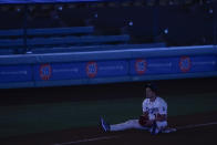 Los Angeles Dodgers left fielder Enrique Hernandez sits on third base during a power outage that stopped a baseball game against the Los Angeles Angels in the seventh inning Saturday, Sept. 26, 2020, in Los Angeles. (AP Photo/Ashley Landis)