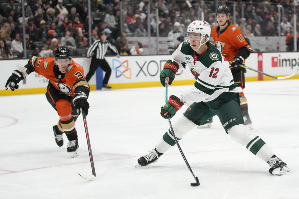 Minnesota Wild left wing Matt Boldy (12) shoots against Anaheim Ducks defenseman John Klingberg (3) during the second period of an NHL hockey game in Anaheim, Calif., Wednesday, Dec. 21, 2022. (AP Photo/Ashley Landis)