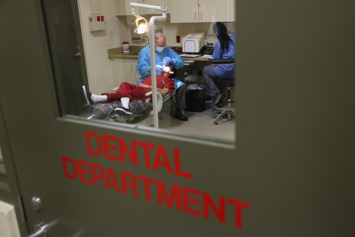 An immigrant receives dental care at the Adelanto Detention Facility in 2013 in Adelanto, Calif. (Photo: John Moore/Getty Images)