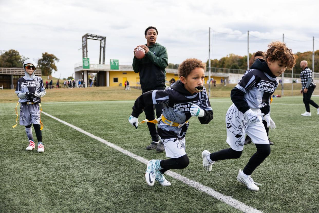 Youth flag football players run drills with their coach before a game in Dayton, Ohio, on Oct. 8, 2023. <a href="https://www.gettyimages.com/detail/news-photo/flag-football-team-beavercreek-raiders-run-drills-with-news-photo/1850858257?adppopup=true" rel="nofollow noopener" target="_blank" data-ylk="slk:Megan Jelinger/The Washington Post via Getty Images;elm:context_link;itc:0;sec:content-canvas" class="link ">Megan Jelinger/The Washington Post via Getty Images</a>
