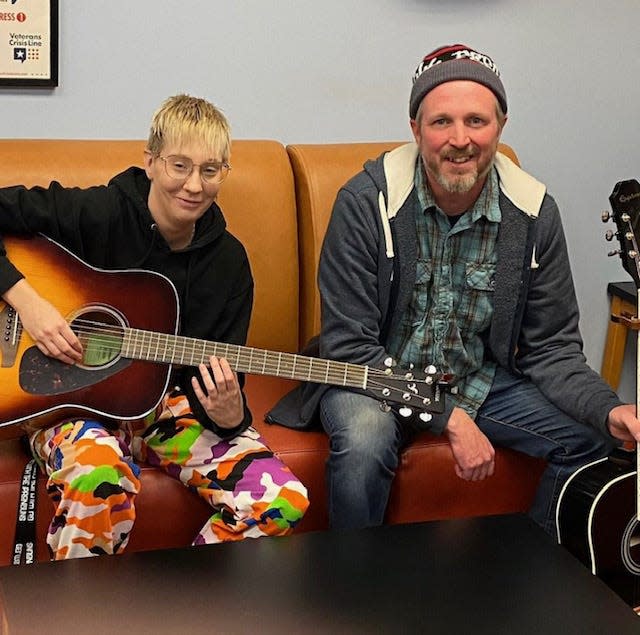 Lindsay Slay poses with instructor Jeremy Linton in the Guitar for Vets class at the South Bend Vet Center.