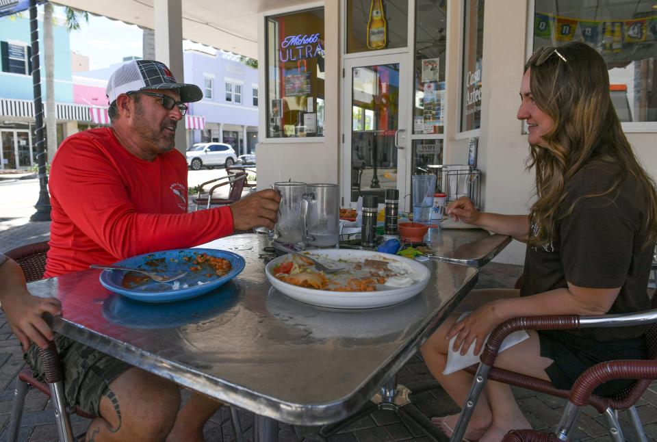 A.J. Aleixo (left), of Down Under Dive Service in Fort Pierce, and his staff member Kristin Morgan finish their meal outside the Mexican restaurant Casa Azteca, at the corner of Orange Avenue and North 2nd Street, where the sound of passing trains are more evident, in downtown Fort Pierce. "So long as the gates are timed right I think we're OK, but if the gates aren't timed right, there’s the potential for giant problems," Aleixo said. "It turns into white noise I think. Downtown people just get used to sounds that happen every day. Initially, I imagine it's going to be shocking for a lot of people, but after a while, hopefully, that will fade into the background."