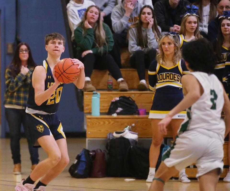 Lourdes' Thomas Simpson lines up a jump shot during the MHAL boys basketball final versus Spackenkill on February 23, 2023. 