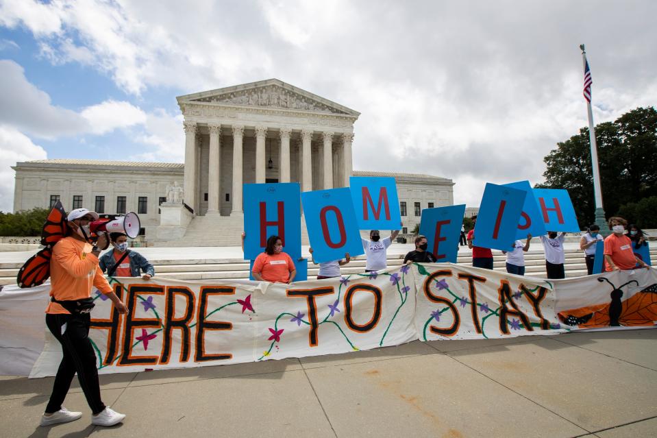 Deferred Action for Childhood Arrivals (DACA) recipient Roberto Martinez, left, celebrates with other DACA recipients in front of the Supreme Court on Thursday, June 18, 2020, in Washington. The Supreme Court on Thursday rejected President Donald Trump’s effort to end legal protections for 650,000 young immigrants, a stunning rebuke to the president in the midst of his reelection campaign. (AP Photo/Manuel Balce Ceneta) ORG XMIT: DCMC105