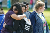 <p>Santa Fe High School freshman Caitlyn Girouard, center, hugs her friend outside the Alamo Gym where students and parents wait to reunite following a shooting at Santa Fe High School Friday, May 18, 2018, in Santa Fe, Texas. (Photo: Michael Ciaglo/Houston Chronicle via AP) </p>