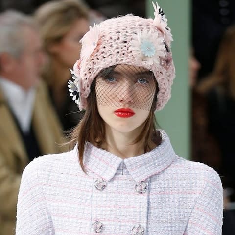 Veiled eyes and red lips at the SS15 show - Credit: IAN LANGSDON/EPA