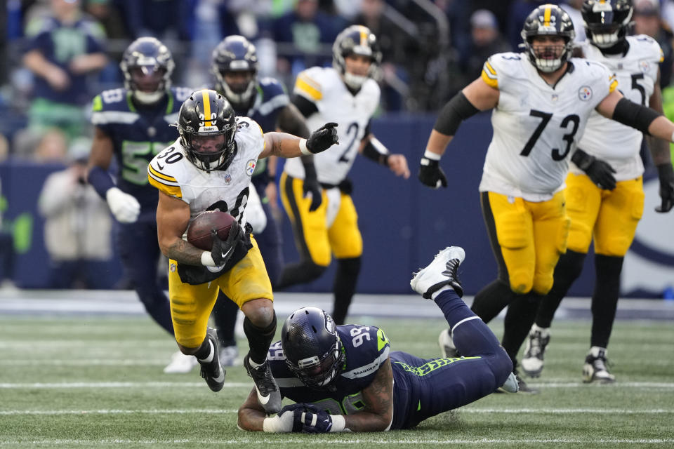 Pittsburgh Steelers running back Jaylen Warren (30) tries to get past Seattle Seahawks defensive end Leonard Williams (99) in the second half of an NFL football game Sunday, Dec. 31, 2023, in Seattle. (AP Photo/Lindsey Wasson)