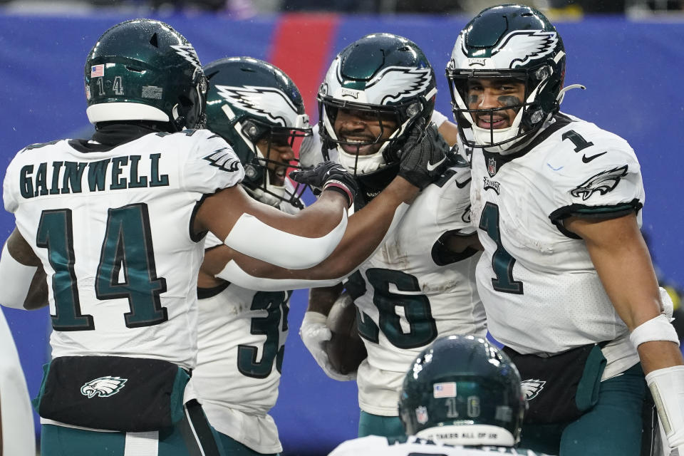 Philadelphia Eagles running back Miles Sanders (26) celebrates with teammates after scoring a touchdown against the New York Giants during the fourth quarter of an NFL football game, Sunday, Dec. 11, 2022, in East Rutherford, N.J. (AP Photo/John Minchillo)