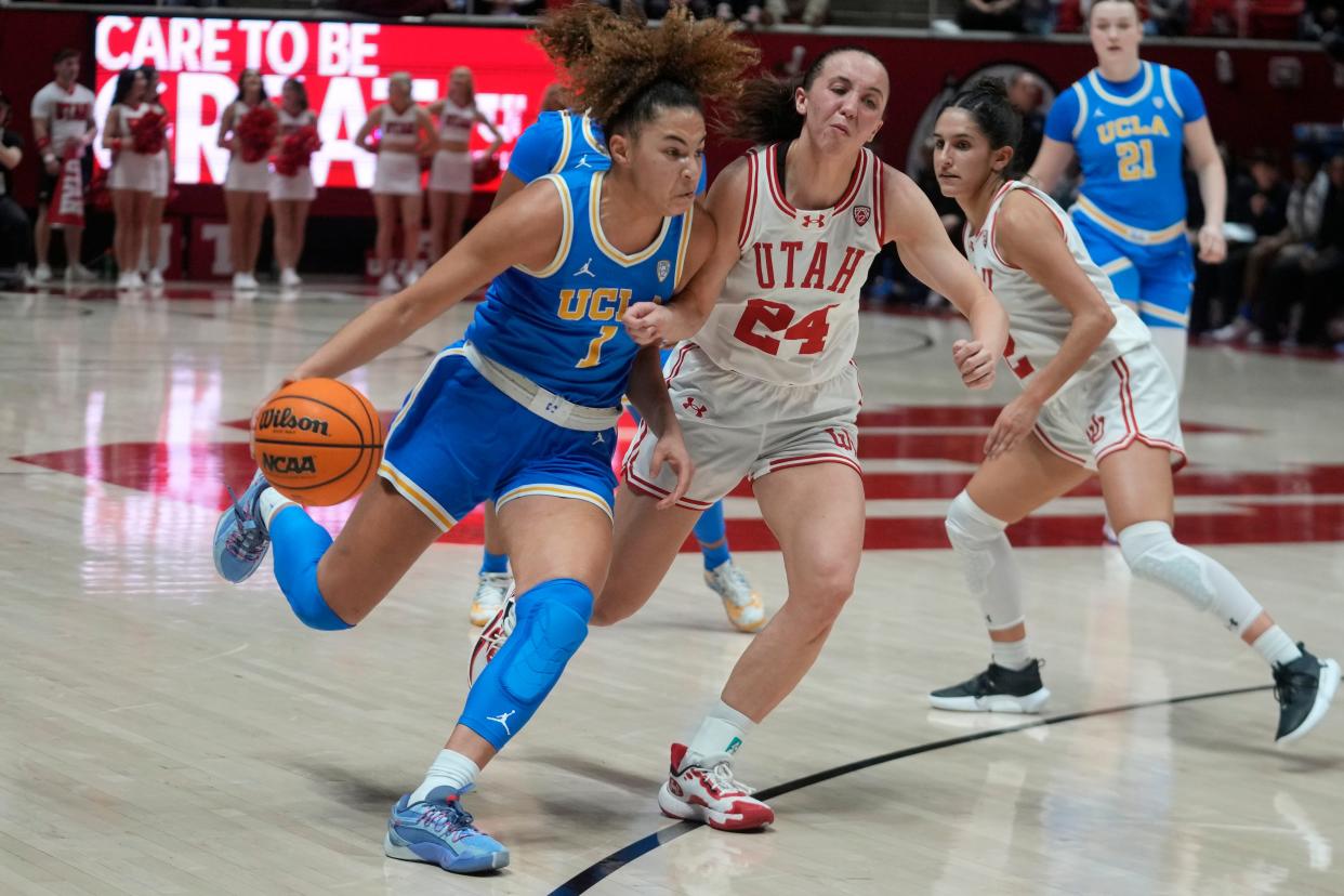 UCLA guard Kiki Rice (1) drives around Utah guard Kennady McQueen (24) during the first half of the game Monday, Jan. 22, 2024, in Salt Lake City.