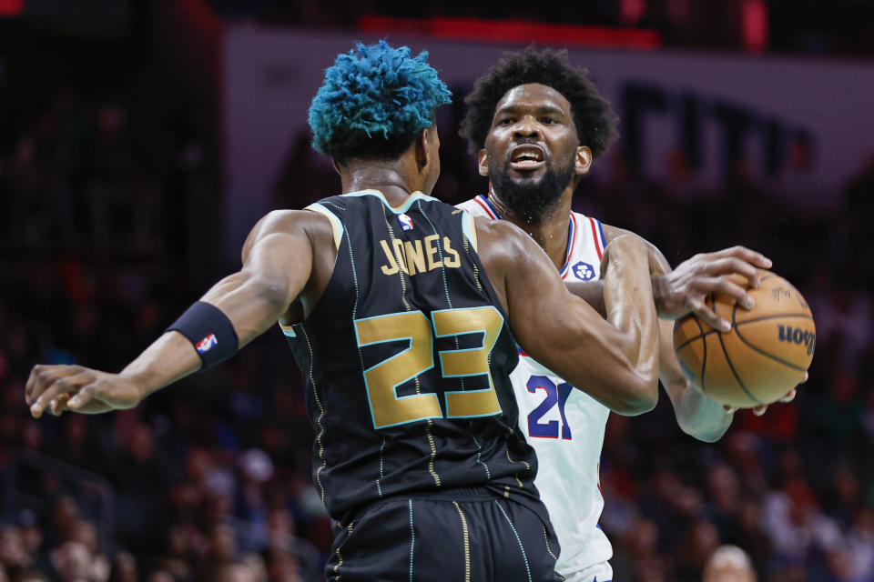 Philadelphia 76ers center Joel Embiid (21) is fouled by Charlotte Hornets forward Kai Jones (23) during the second half of an NBA basketball game in Charlotte, N.C., Friday, March 17, 2023. (AP Photo/Nell Redmond)