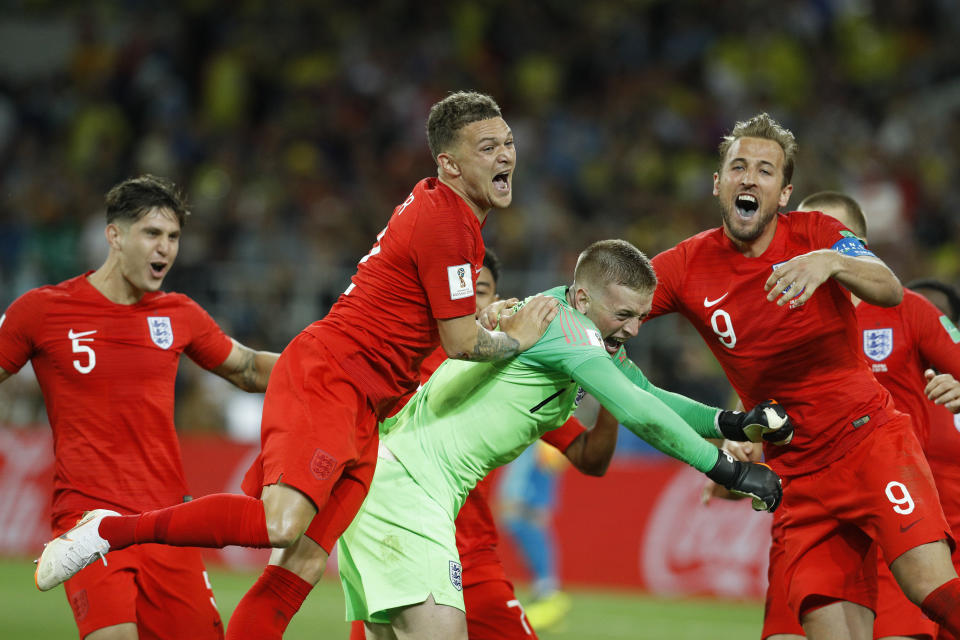 <p>Harry Kane, Kieran Trippier, and John Stones mob goalkeeper Jordan Pickford after England won their first penalty shoot-out since 1996. </p>