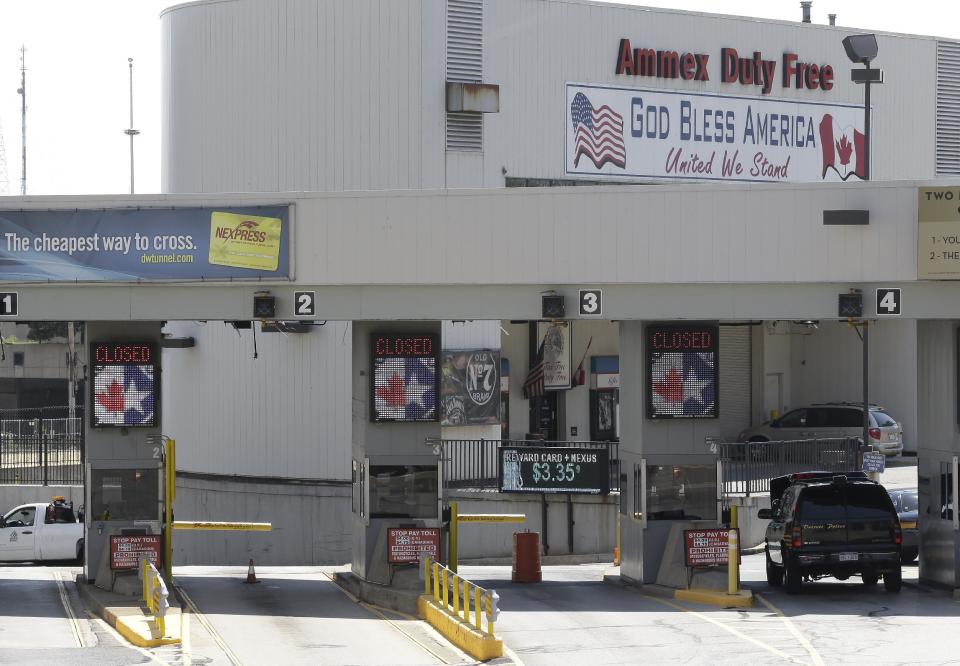 Entry lanes are shown closed as authorities investigate a bomb threat at the Detroit Windsor Tunnel Thursday, July 12, 2012. The tunnel was closed to traffic after the threat was called in on the Canadian side, tunnel chief executive Neal Belitsky told The Associated Press. The call was made some time after 12:30 p.m. to the duty free shop on a plaza on the tunnel's Windsor side, tunnel executive vice president Carolyn Brown said. (AP Photo/Paul Sancya)