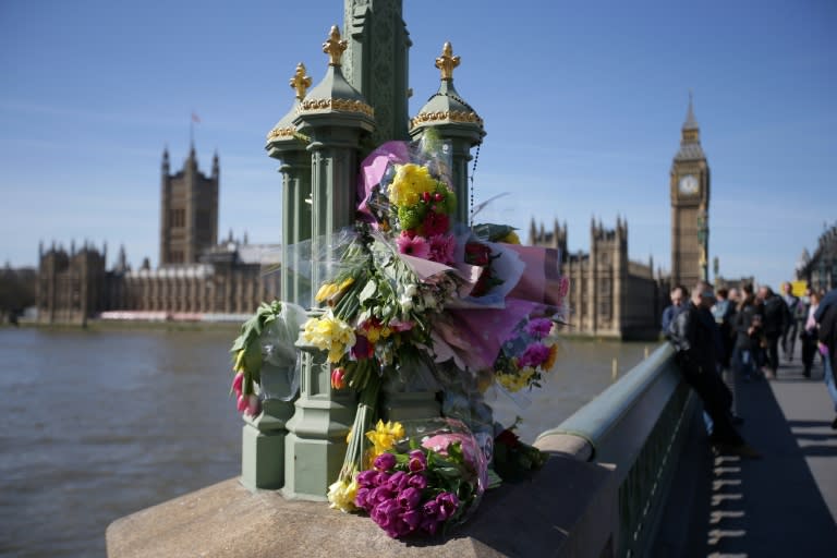 Floral tributes to the victims of the March 22 terror attack are seen on Westminster Bridge near the Houses of Parliament in central London