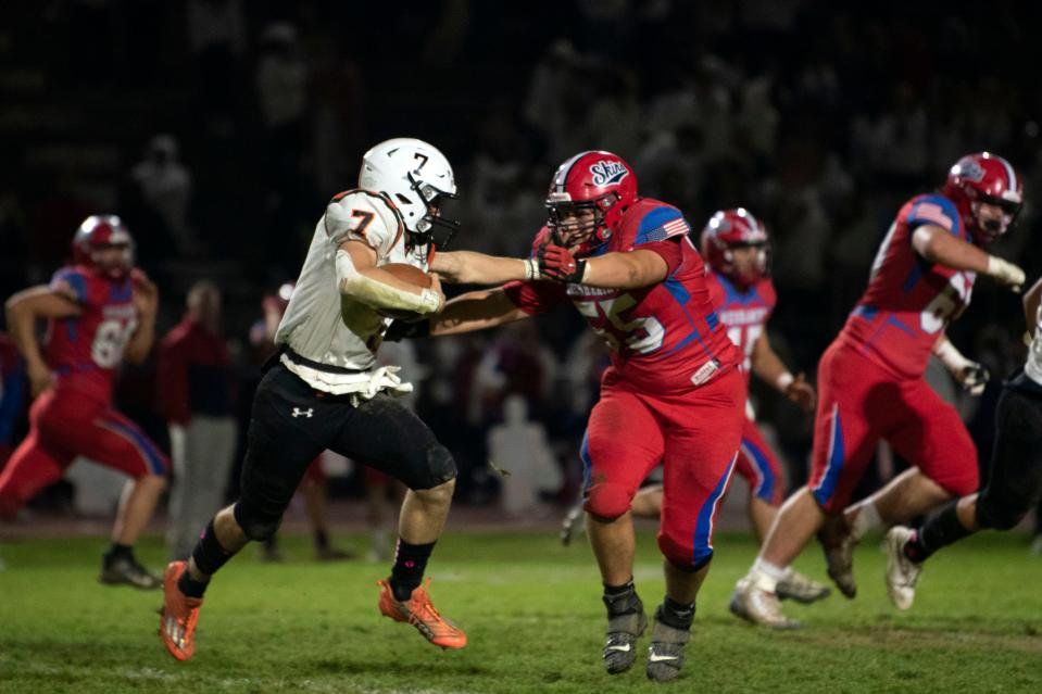 Pennsbury's Nathan Beighley stiff-arms Neshaminy's Kyler Nelson during the Falcons' 2022 victory.