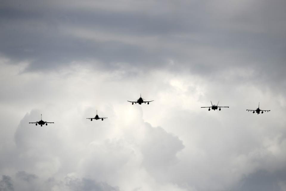 Fighter jets fly during the international military exercise Iniochos at Andravida air base, about 279 kilometres (174 miles) southwest of Athens, Tuesday, April 20, 2021. Greece vowed Tuesday to expand military cooperation with traditional NATO allies as well as Middle Eastern powers in a race to modernize its armed forces and face its militarily assertive neighbor Turkey. (AP Photo/Thanassis Stavrakis)