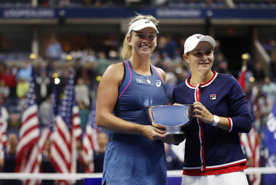 CoCo Vandeweghe, left, and Ashleigh Barty, of Australia, hold the trophy after defeating Timea Babos, of Hungary, and Kristina Mladenovic, of France,in the women's double final of the U.S. Open tennis tournament, Sunday, Sept. 9, 2018, in New York. (AP Photo/Adam Hunger)