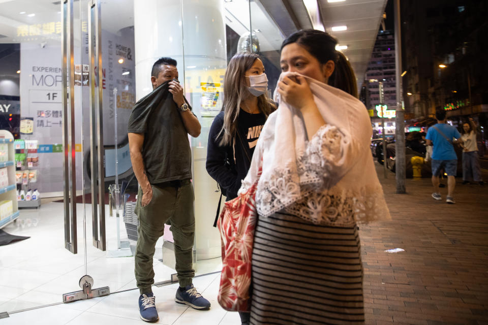 Bystanders react to tear gas during a protest in the Jordan district of Hong Kong, China, on Monday, Nov. 18, 2019. | Kyle Lam/Bloomberg via Getty Images