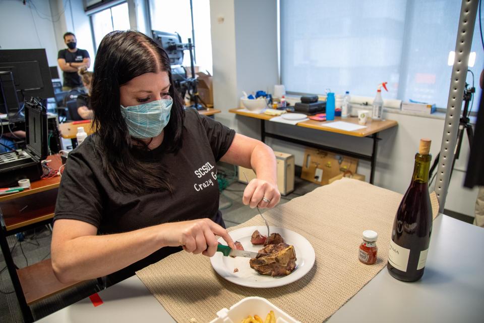 Stroke patient Heather Rendulic cuts steak by herself for the first time in nearly a decade at the Rehab Neural Engineering Labs at the University of Pittsburgh.