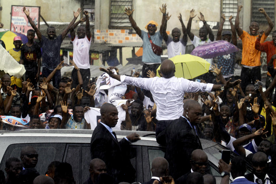 Ivory Coast's former youth minister Charles Ble Goude is cheered by supporters upon his return to Abidjan, Ivory Coast, Saturday Nov. 26, 2022, after more than a decade in exile. Ble Goude was acquitted of charges linked to the violence that erupted after the disputed 2010 election when then President Laurent Gbagbo refused to concede. (AP Photo/Diomande Bleblonde)