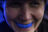 A member of the Long Island Roller Rebels, wears a mouthguard for a practice, Tuesday, March 19, 2023, at United Skates of America in Seaford, N.Y. (AP Photo/Jeenah Moon)