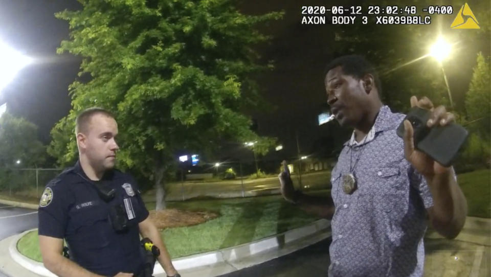 FILE - This screen grab taken from body camera video provided by the Atlanta Police Department shows Rayshard Brooks speaking with Officer Garrett Rolfe, left, in the parking lot of a Wendy's restaurant, late Friday, June 12, 2020, in Atlanta. Rolfe, who fatally shot Rayshard Brooks in the back after the fleeing man pointed a stun gun in his direction, was charged with felony murder and 10 other charges, announced Wednesday, June 17, 2020. Rolfe was fired after the shooting. (Atlanta Police Department via AP)