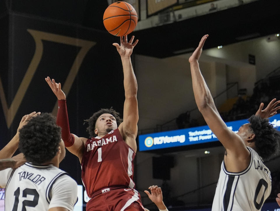 Alabama guard Mark Sears (1) shoots over Vanderbilt's Evan Taylor, left, and guard Tyrin Lawrence, right, during the second half of an NCAA college basketball game Saturday, Jan. 6, 2024 in Nashville, Tenn. Alabama won 78-75. (AP Photo/George Walker IV)