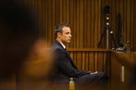 Olympic and Paralympic track star Oscar Pistorius sits in the dock during court proceedings at the North Gauteng High Court in Pretoria, March 13, 2014. Pistorius is on trial for murdering his girlfriend Reeva Steenkamp at his suburban Pretoria home on Valentine's Day last year. REUTERS/Alet Pretorius/Media24/Pool (SOUTH AFRICA - Tags: SPORT CRIME LAW ATHLETICS)