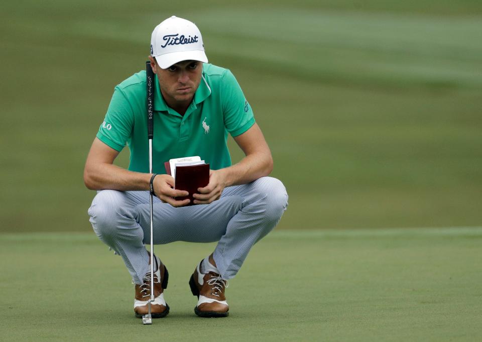 Justin Thomas checks his notes on the 10th green during the first round of the Wyndham Championship golf tournament in Greensboro, N.C., Thursday, Aug. 18, 2016. (AP Photo/Chuck Burton)