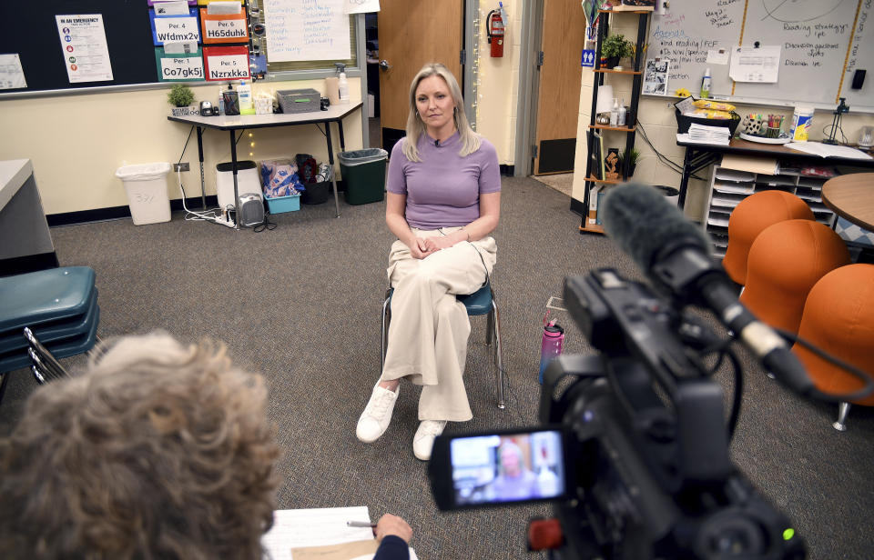 Heather Martin is interviewed in Aurora, Colo., on Thursday, April 11, 2024. Martin, a survivor of the 1999 shooting at Columbine High School in suburban Denver, hid with 60 other students in a barricaded office during the attack. It's been a quarter-century since two gunmen killed 12 fellow students and a teacher at the school, and the trauma of that day continues to shadow Martin and others who were there. (AP Photo/Thomas Peipert)