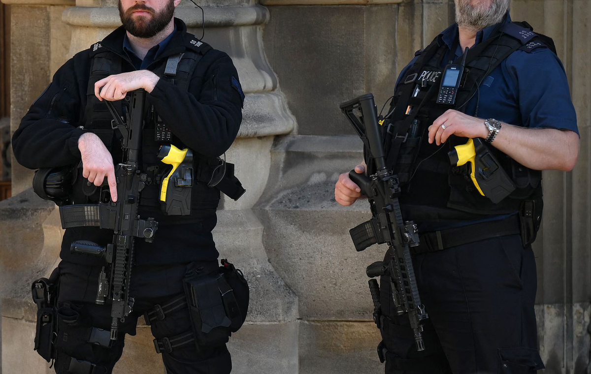 Armed police officers on duty outside the Houses of Parliament (AFP via Getty Images)