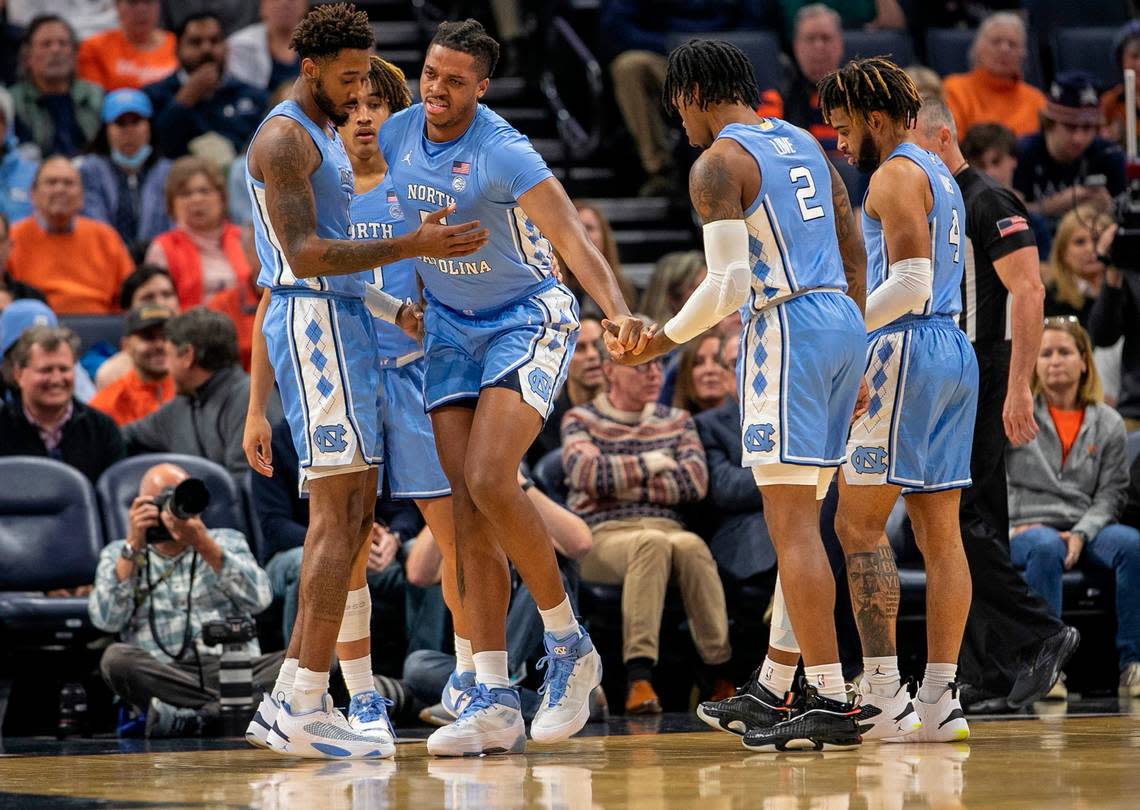 North Carolina’s Armando Bacot (5) is helped off the court after an injury in the opening minutes of play against Virginia on Tuesday, January 10, 2023 at John Paul Jones Arena in Charlottesville, Va.