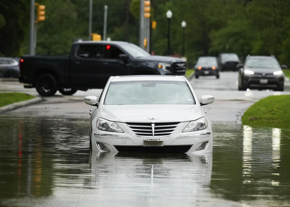 A stalled car is seen in flood water near North Park Drive after severe flooding, Thursday, May 2, 2024, in the Houston neighborhood of Kingwood, Texas. (Jason Fochtman/Houston Chronicle via AP)