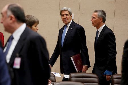 U.S. Secretary of State John Kerry (C) arrives with NATO Secretary General Jens Stoltenberg (R) for a NATO ministerial meeting on Resolute Support operations in Afghanistan, at NATO Headquarters in Brussels December 1, 2015. REUTERS/Jonathan Ernst