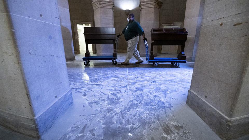 Capitol workers remove damaged furniture on the first floor of the Senate side of the U.S. Capitol on Thursday morning, January 7, 2021, following the riot at the Capitol the day before.
