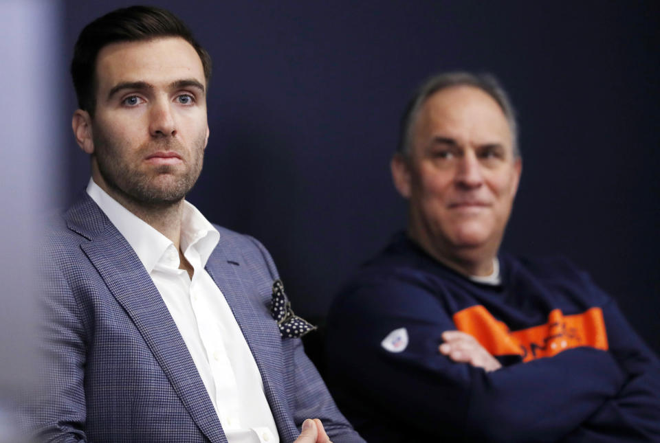 Denver Broncos new quarterback Joe Flacco, left, waits with head coach Vic Fangio to talk to reporters at a news conference at the NFL football team's headquarters Friday, March 15, 2019, in Englewood, Colo. (AP Photo/David Zalubowski)