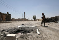 <p>A Syrian Democratic Forces (SDF) fighter walks past a crater in Raqqa’s western neighbourhood of Jazra, Syria June 11, 2017. (Photo: Rodi Said/Reuters) </p>