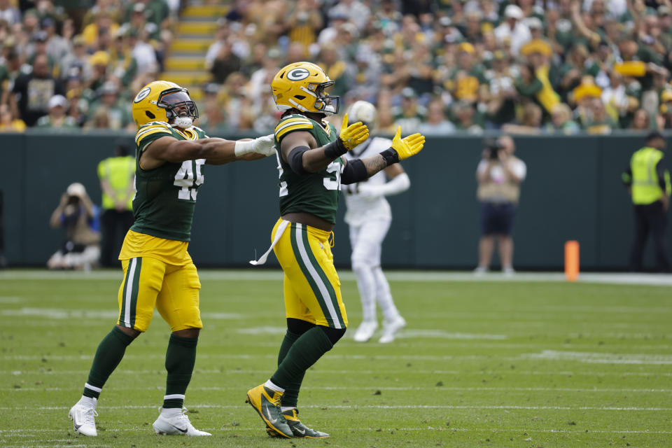 Green Bay Packers linebacker Rashan Gary (52) celebrates with linebacker Eric Wilson (45) during the second half of an NFL football game against the New Orleans Saints Sunday, Sept. 24, 2023, in Green Bay, Wis. (AP Photo/Mike Roemer)