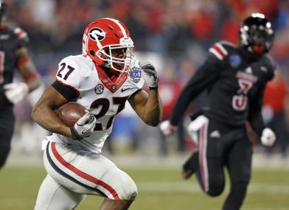 Georgia's Nick Chubb (27) runs for a touchdown against Louisville during the first half of the Belk Bowl NCAA college football game in Charlotte, N.C., Tuesday, Dec. 30, 2014. (AP Photo/Nell Redmond)