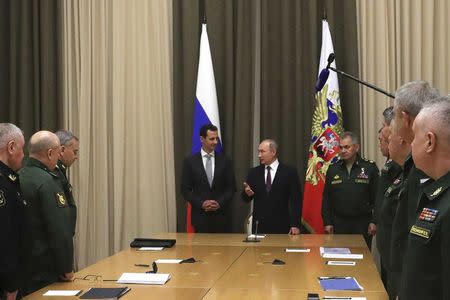 Russian President Vladimir Putin (5th L), Syrian President Bashar al-Assad (4th L), Russian Defence Minister Sergei Shoigu (6th L) and other high-ranking servicemen attend a meeting in the Black Sea resort of Sochi, Russia November 20, 2017. Picture taken November 20, 2017. Sputnik/Mikhail Klimentyev/Kremlin via REUTERS ATTENTION EDITORS - THIS IMAGE WAS PROVIDED BY A THIRD PARTY.