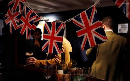 People drink beer at a Pro-Brexit event to celebrate the invoking of Article 50 after Britain's Prime Minister Theresa May triggered the process by which the United Kingdom will leave the European Union, in London, Britain March 29, 2017. REUTERS/Peter Nicholls/Files