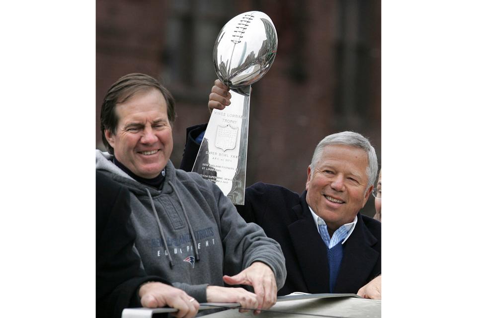 FILE - New England Patriots head coach Bill Belichick, left, smiles as team owner Robert Kraft holds up the Vince Lombardi trophy during a Super Bowl victory parade in Boston, Tuesday, Feb . 8, 2005. The Patriots beat the Philadelphia Eagles 24-21 in Super Bowl XXXIX. Six-time NFL champion Bill Belichick has agreed to part ways as the coach of the New England Patriots on Thursday, Jan. 11, 2024, bringing an end to his 24-year tenure as the architect of the most decorated dynasty of the league’s Super Bowl era, a source told the Associated Press on the condition of anonymity because it has not yet been announced. (AP Photo/Michael Dwyer, File)