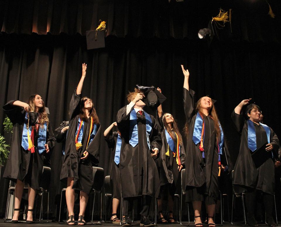Sumner County Middle College High School Graduates toss their mortar boards in the air after Commencement on Saturday, May 21, 2022. 